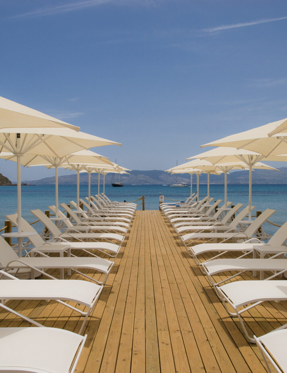 Pier with sun loungers and the sea